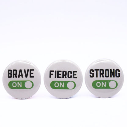 BooBooRoo Pinback Button (i.e. button, badge, pin) 3-pack displaying brave, fierce, and strong modes are on. Green background for mode indicator.