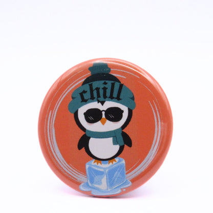 BooBooRoo Pinback Button (i.e. button, badge, pin) of a Cute Kawaii Style penguin standing on an ice cube and wearing a beanie that says, "Chill." 