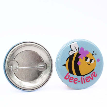 BooBooRoo Pinback Button (i.e. button, badge, pin) of a Cute Kawaii Style Bee with the pun Bee-lieve. Image showing front and back of high-quality metal button.