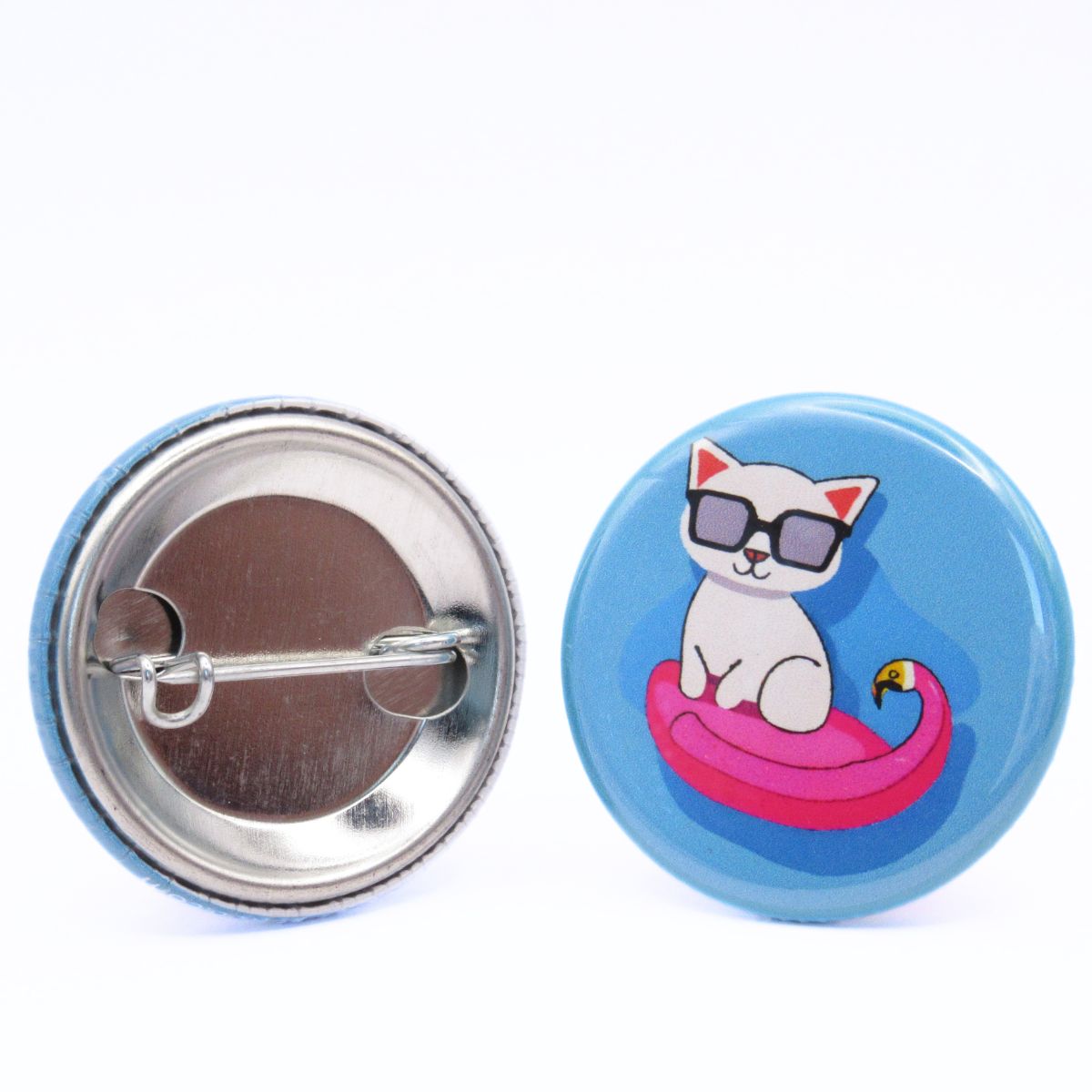 BooBooRoo Pinback Button (i.e. button, badge, pin) of a white cat wearing sunglasses sitting in a flamingo pool floatie. Image showing front and back of high-quality metal button.