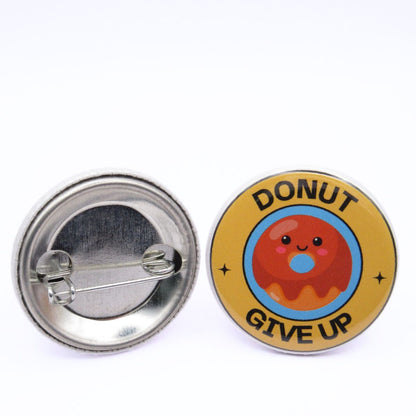 BooBooRoo Pinback Button (i.e. button, badge, pin) of a Cute Kawaii Style donut with the saying "Donut Give Up." Image showing front and back of high-quality metal button.
