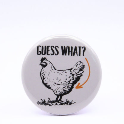 BooBooRoo Pinback Button (i.e. button, badge, pin) displaying a chicken with the words, "Guess What" and an arrow pointing to the chicken's butt.