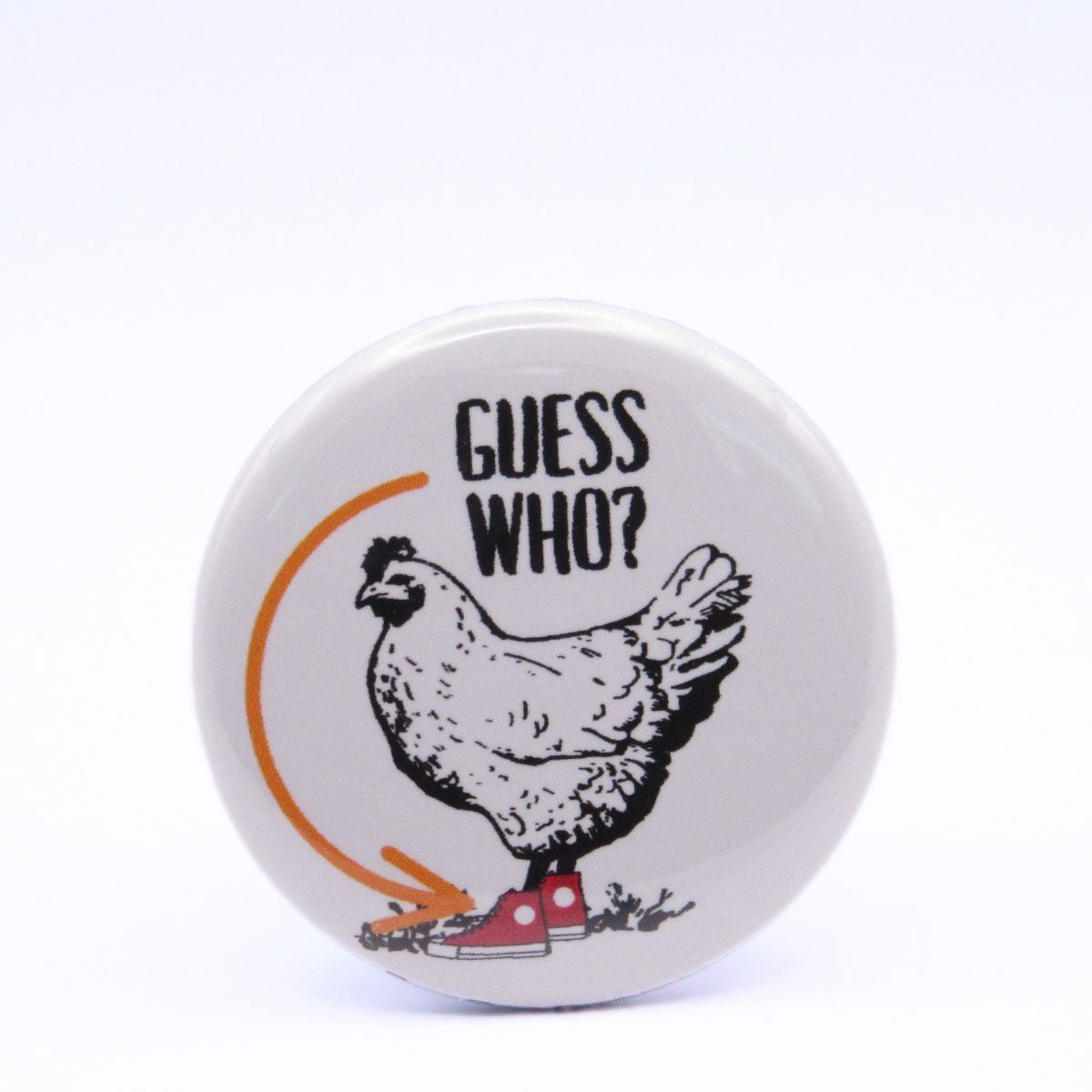 BooBooRoo Pinback Button (i.e. button, badge, pin) displaying a chicken with the words, "Guess Who" and an arrow pointing to the chicken's red high-top shoe.