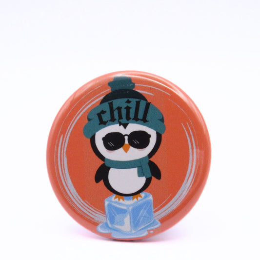 BooBooRoo Pinback Button (i.e. button, badge, pin) of a Cute Kawaii Style penguin standing on an ice cube and wearing a beanie that says, "Chill." 