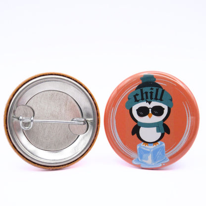 BooBooRoo Pinback Button (i.e. button, badge, pin) of a Cute Kawaii Style penguin standing on an ice cube and wearing a beanie that says, "Chill." Image showing front and back of high-quality metal button.