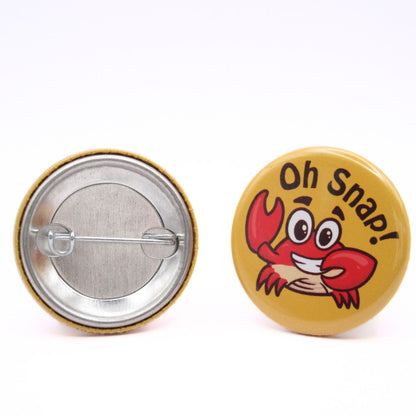 BooBooRoo Pinback Button (i.e. button, badge, pin) of a crab saying, "Oh Snap!" Image showing front and back of high-quality metal button.