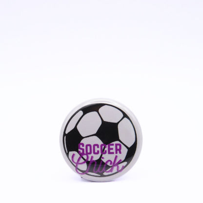BooBooRoo Pinback Button (i.e. button, badge, pin) displaying a soccer ball and the words, "Soccer Chick." Black soccer ball with purple text.