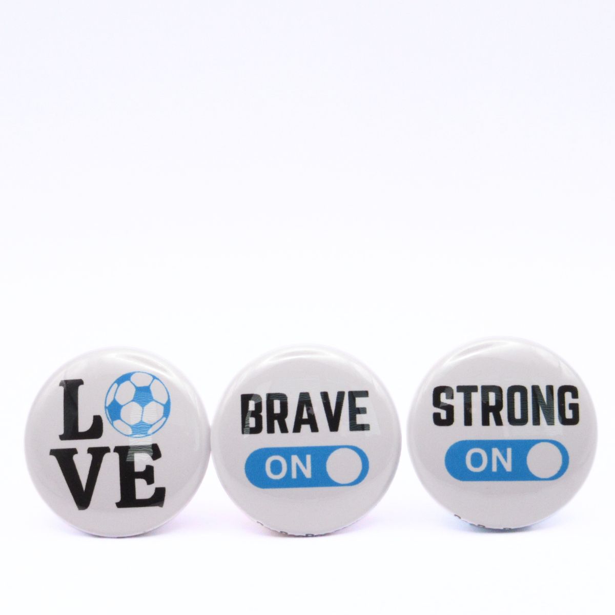 BooBooRoo Pinback Button (i.e. button, badge, pin) 3-pack displaying soccer love, fierce mode on, and strong mode on. Blue background for mode indicator and soccer ball.