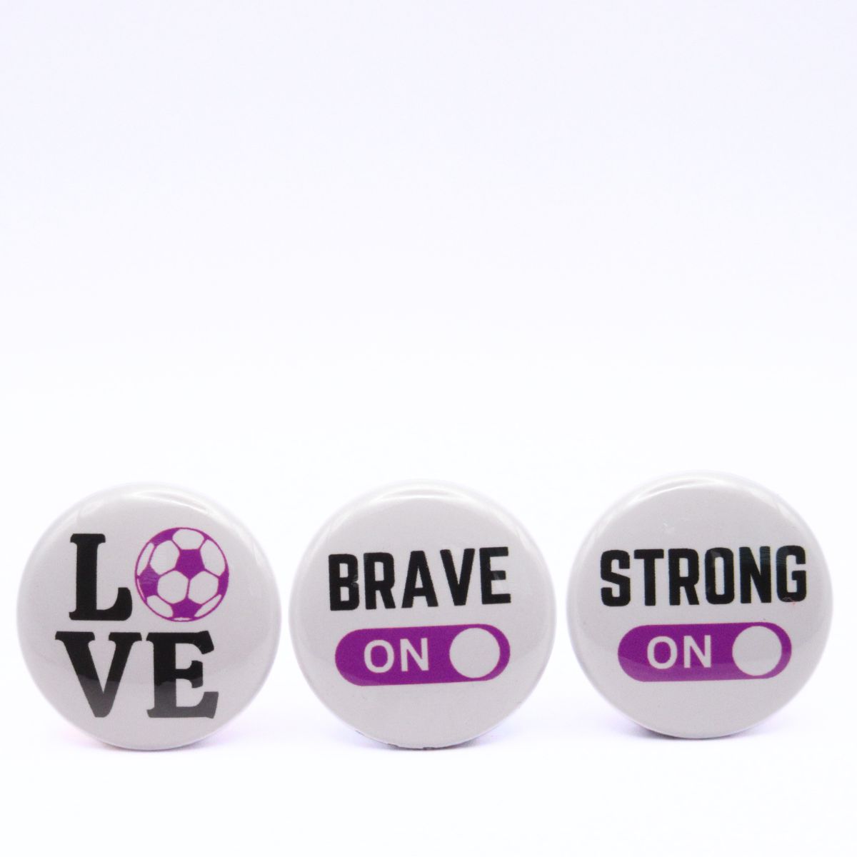 BooBooRoo Pinback Button (i.e. button, badge, pin) 3-pack displaying soccer love, fierce mode on, and strong mode on. Purple background for mode indicator and soccer ball.