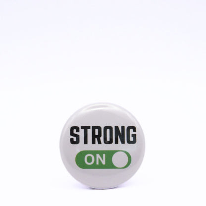 BooBooRoo Pinback Button (i.e. button, badge, pin) displaying strong mode is on. Green background for mode indicator.